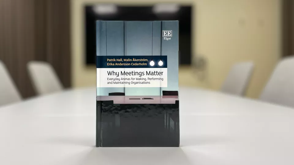 A book on a table in an empty conference room.
