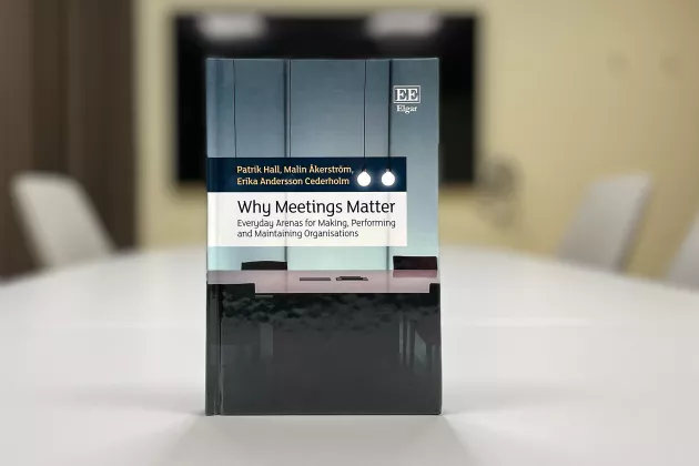 A book on a table in an empty conference room.