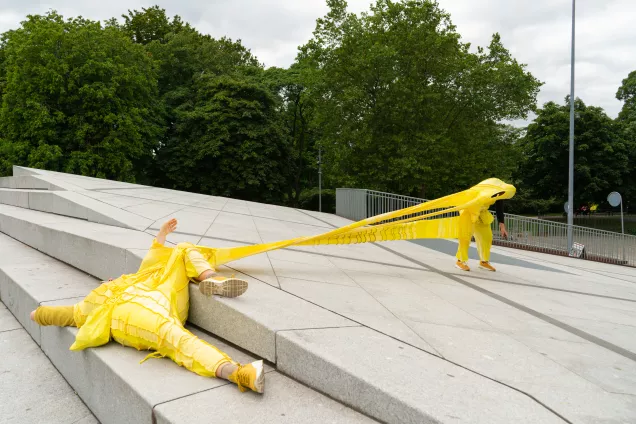 Person in yellow costume in art performance. 